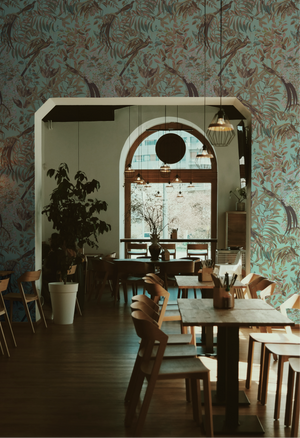 Resplendent Woods superwide wallpaper by Deus ex Gardenia in dark green, peacocks and pheasants in trees in an entryway