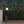 Resplendent Woods superwide wallpaper by Deus ex Gardenia in dark green, peacocks and pheasants in trees in a living room