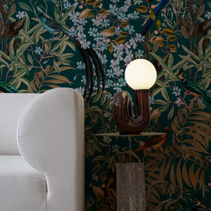 Resplendent Woods superwide wallpaper by Deus ex Gardenia in dark green in a styled room setting