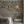 Resplendent Woods superwide wallpaper by Deus ex Gardenia in cream and green, peacocks and pheasants in trees behind a bed