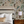 Resplendent Woods wallpaper by Deus ex Gardenia in teal, peacocks and pheasants in trees in a bedroom