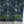 Beechcroft Garden wallpaper by Deus ex Gardenia in navy, garden flowers and foliage behind a sofa in a living room