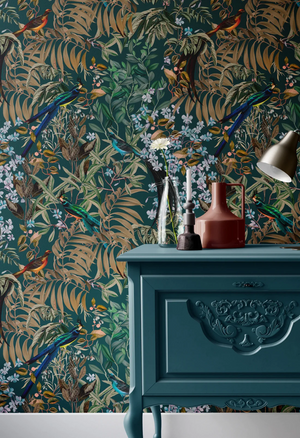 Resplendent Woods superwide wallpaper by Deus ex Gardenia in dark green, peacocks and pheasants in trees above a sideboard