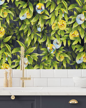 Disco Lemons wallpaper by Brand McKenzie in green and yellow, lemon branches with disco balls above kitchen cabinets