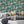Downtown Deco wallpaper by Brand McKenzie in teal, Art Deco skyscrapers in a living room