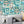 Downtown Deco wallpaper by Brand McKenzie in mint green, Art Deco skyscrapers on a living room wall