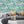 Downtown Deco wallpaper by Brand McKenzie in mint green, Art Deco skyscrapers in a living room