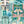 Downtown Deco wallpaper by Brand McKenzie in mint green, close view of Art Deco skyscrapers