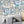 Downtown Deco wallpaper by Brand McKenzie in pale blue, Art Deco skyscrapers on a living room wall