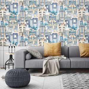 Downtown Deco wallpaper by Brand McKenzie in pastel and blue, Art Deco skyscrapers behind a sofa in a living room