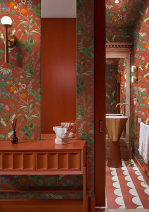 Eden wallpaper by Deus ex Gardenia in orange, lush leaves and fruit in an entryway