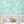 Elephant Breaststroke wallpaper by Brand McKenzie in aqua behind a daybed in a child's room