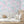 Elephant Breaststroke wallpaper by Brand McKenzie in pink behind a daybed in a child's room