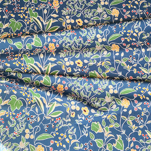 Emmanuelle linen by Claire de Quénetain in blue and green, draped, showing a hand-painted floral design