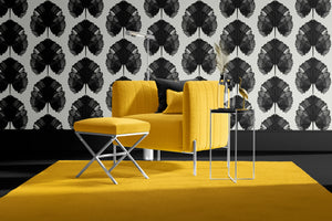 Empress Fan wallpaper by Liberty James Studio in black, art deco fan leaves behind a sofa in a living room