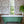 Eversley Grasscloth grasscloth by Parker and Jules in pink and brown, trailing roses in a bathroom