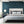 Exotic Birds wallpaper by Brand McKenzie in navy, hummingbirds in flight on a bedroom wall
