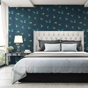 Exotic Birds wallpaper by Brand McKenzie in navy, hummingbirds in flight on a bedroom wall