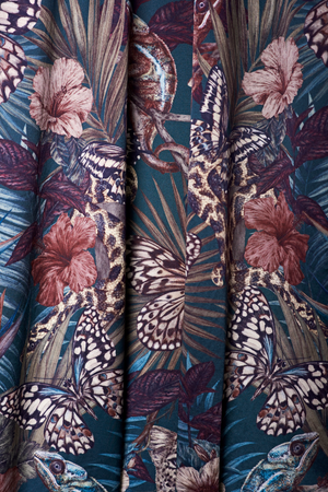 Exotica velvet by Victoria Sanders in petrol blue, jungle animals and tropical flowers hung as curtains