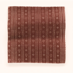 Birdlip linen by Parker and Jules in red, draped, showing a small block-print stripe
