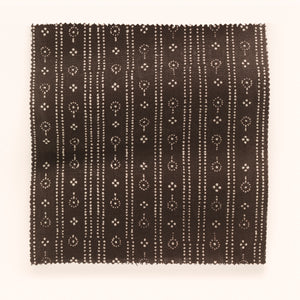 Birdlip linen by Parker and Jules in brown, draped close-up of a small block-print stripe