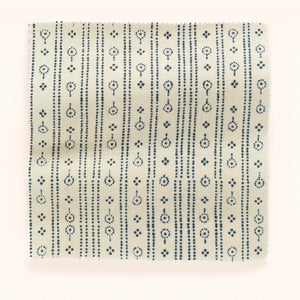 Birdlip linen by Parker and Jules in white and navy, draped close-up of a small block-print stripe