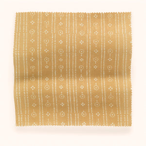 Birdlip linen by Parker and Jules in yellow, draped, showing a small block-print stripe