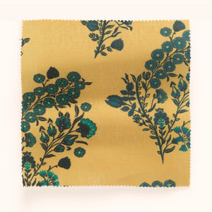 Coromandel Flower linen by Parker and Jules in yellow, in soft folds showing paisley flower sprays