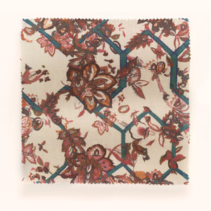 Creeping Trellis linen by Parker and Jules in red, draped close-up of flowers on a trellis