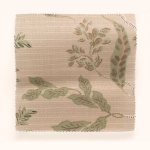 Eversley linen by Parker and Jules in beige and green, in soft folds showing trailing roses