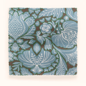 Folk Floral linen by Parker and Jules in blue, draped close-up of bold folk flowers