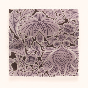 Folk Floral linen by Parker and Jules in lilac, draped, showing bold folk flowers