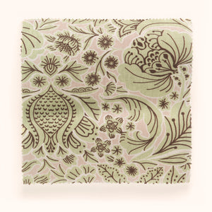 Folk Floral linen by Parker and Jules in green, draped close-up of bold folk flowers