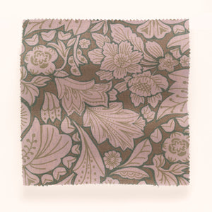 Folk Floral linen by Parker and Jules in brown, draped, showing bold folk flowers