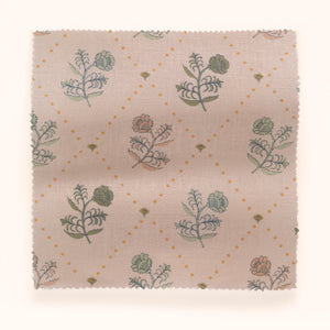 Jaipur linen by Parker and Jules in pink and green, draped, showing block-print flower sprigs