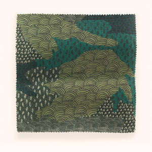 Ordnance Survey linen linen by Parker and Jules in green, draped, showing a map-style camouflage print