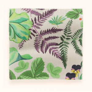 Strawberry Fields linen by Parker and Jules in green, draped, showing strawberries, ferns and pansies