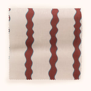 Scroll Stripe linen by Parker and Jules in red, draped, showing wavy scroll stripes