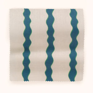 Scroll Stripe linen by Parker and Jules in blue, draped close-up of wavy scroll stripes