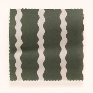 Scroll Stripe linen by Parker and Jules in dark green, draped close-up of wavy scroll stripes