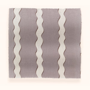 Scroll Stripe linen by Parker and Jules in dusky pink, in soft folds showing wavy scroll stripes