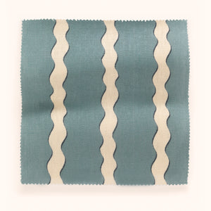 Scroll Stripe linen by Parker and Jules in blue, in soft folds showing wavy scroll stripes