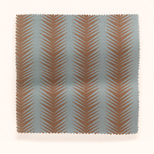 Ziggy linen by Parker and Jules in aqua and terracotta, draped, showing a chevron zigzag weave