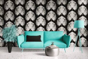 Empress Fan wallpaper by Liberty James Studio in white, art deco fan leaves behind a sofa in a living room