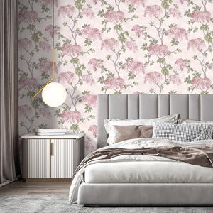 Feather Palm wallpaper by Brand McKenzie in pink, peony blossoms and palms behind a bed