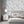 Feather Palm wallpaper by Brand McKenzie in blue, peony blossoms and palms on a bedroom wall