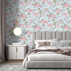 Feather Palm wallpaper by Brand McKenzie in blue, peony blossoms and palms on a bedroom wall
