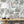 Fiesta wallpaper by Brand McKenzie in peach, a festive procession of elephants behind a console table