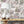 Fiesta wallpaper by Brand McKenzie in pink and green, a festive procession of elephants above a sideboard