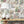 Fiesta wallpaper by Brand McKenzie in red and green, a festive procession of elephants above a sideboard